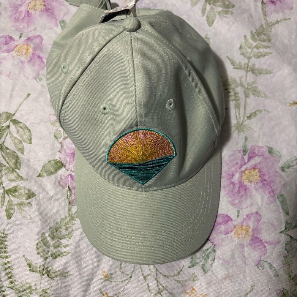 Pastel Green Cap with Embroidered Sun Design